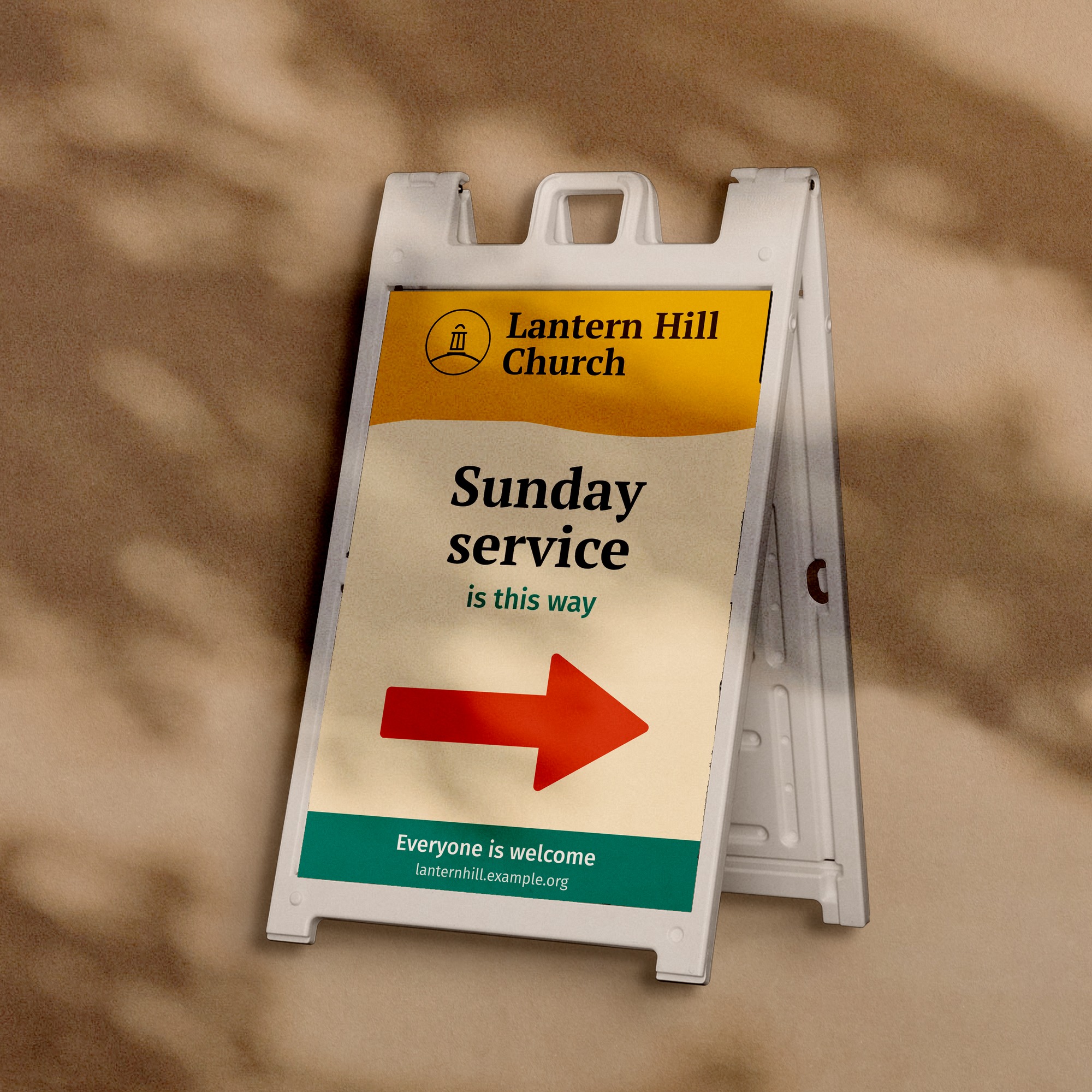 Sidewalk sign with an arrow for a church plant, a sample design on a plaster wall