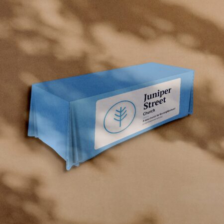 Fitted table cover with a Juniper Street Church sample design on the front