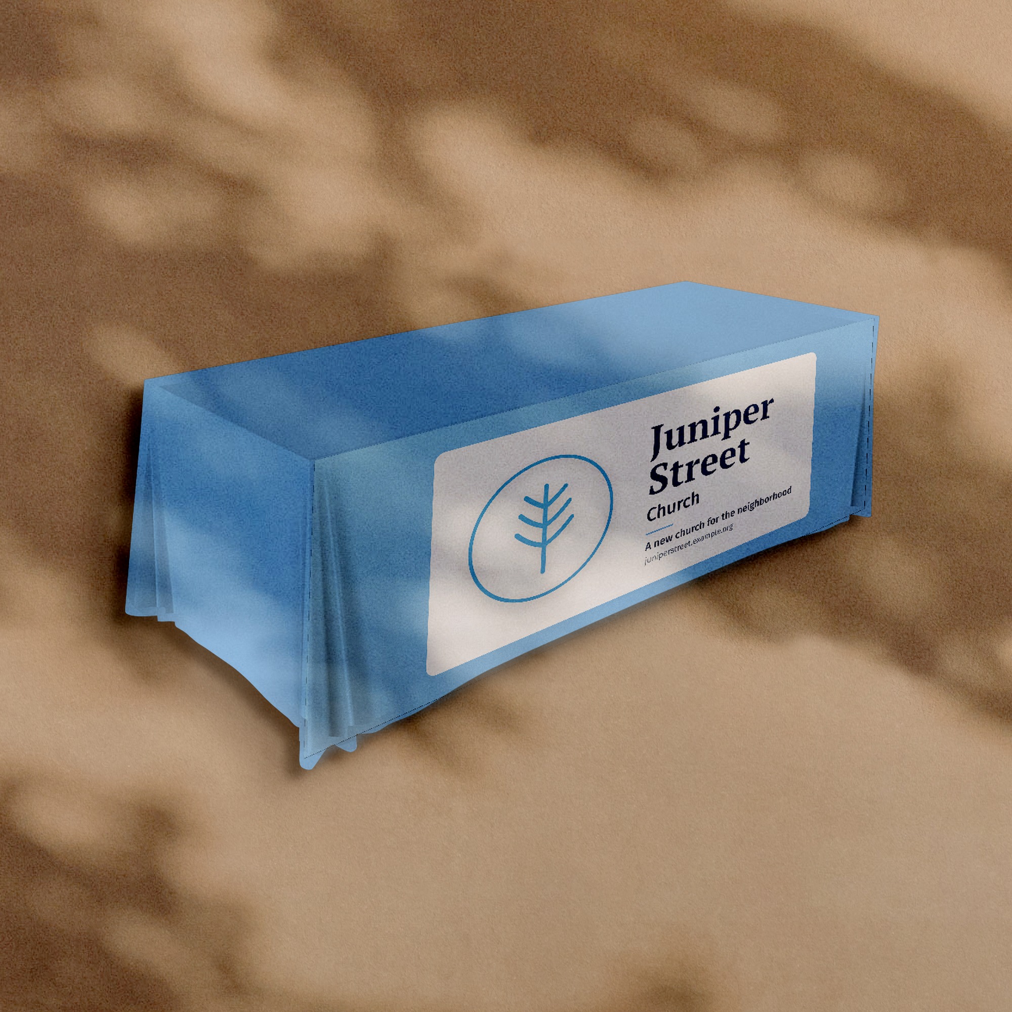 Fitted table cover with a Juniper Street Church sample design on the front