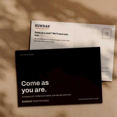 Postcards, front and back, in window light