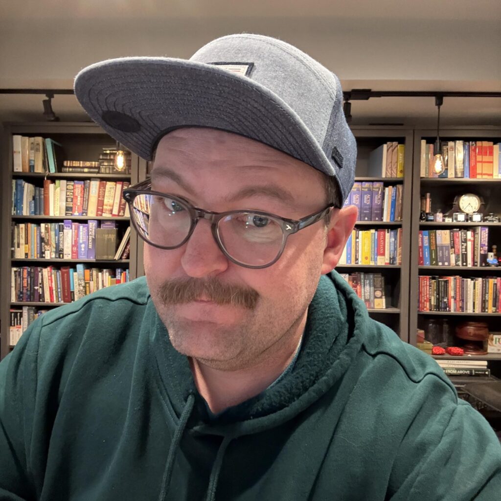 Samuel Scalf in his study, in front of his bookshelves